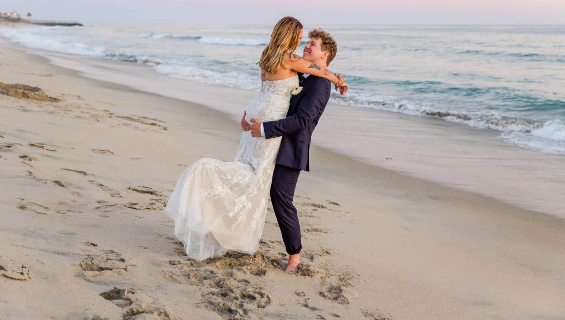 Couple at the beach on their wedding day captured by Carlsbad Photo at Tamarack Beach in Carlsbad