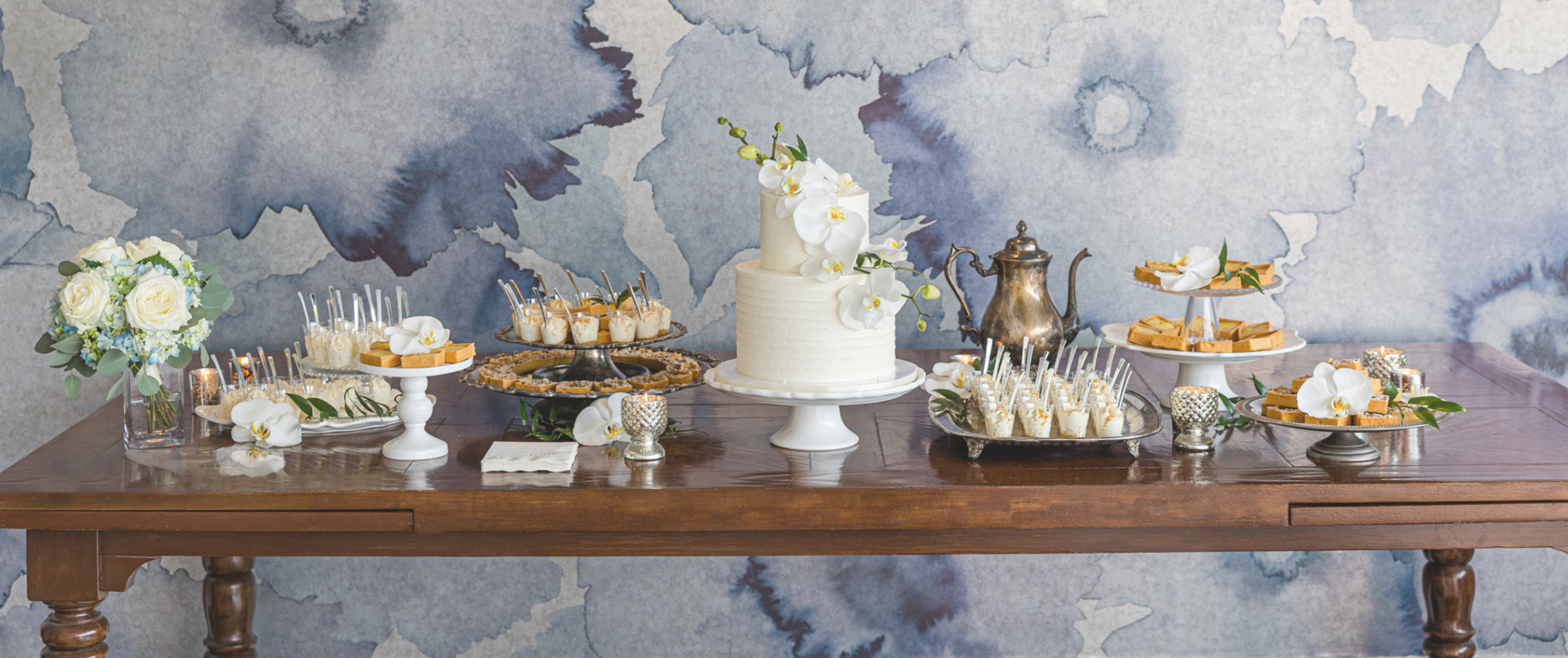 Sweet table with wedding cake captured by Carlsbad Photo at La Valencia Hotel La Jolla