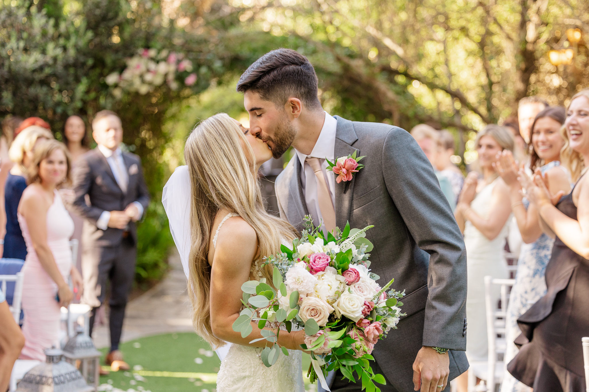 Bride and Groom kissing after the wedding ceremony at Twin Oaks Garden captured by Carlsbad Photo